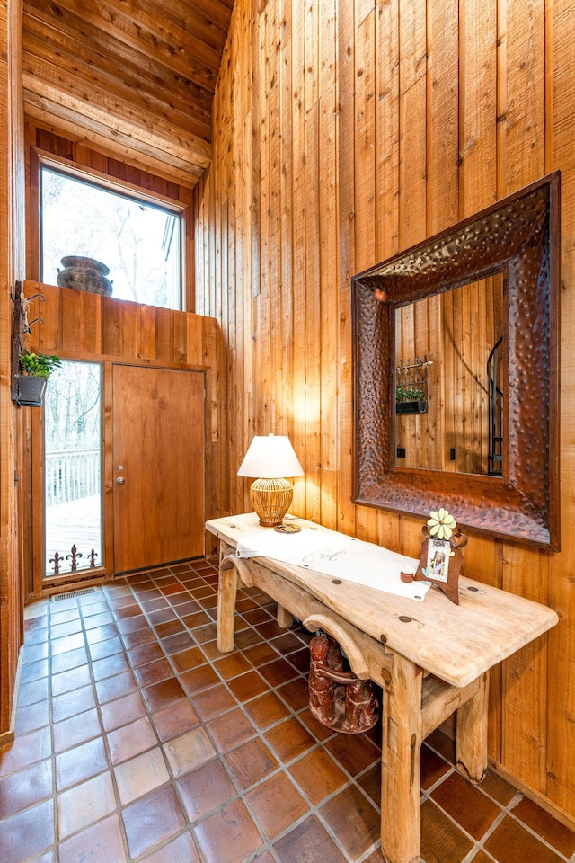 interior space featuring wood ceiling and wood walls