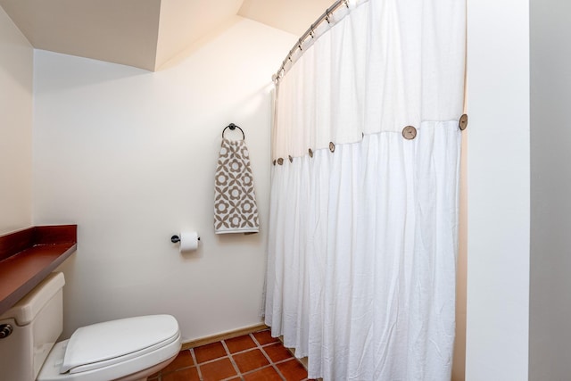 full bathroom with baseboards, toilet, and tile patterned floors