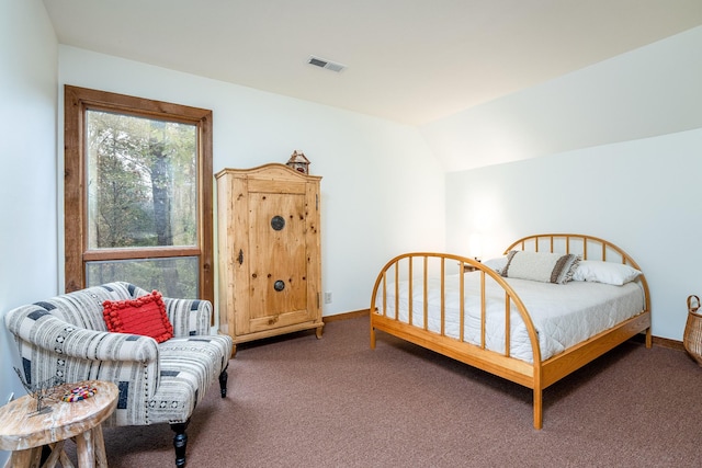 bedroom with carpet floors, visible vents, vaulted ceiling, and baseboards