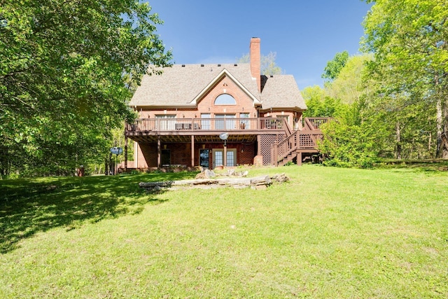 back of house featuring a wooden deck, a chimney, stairs, a yard, and brick siding