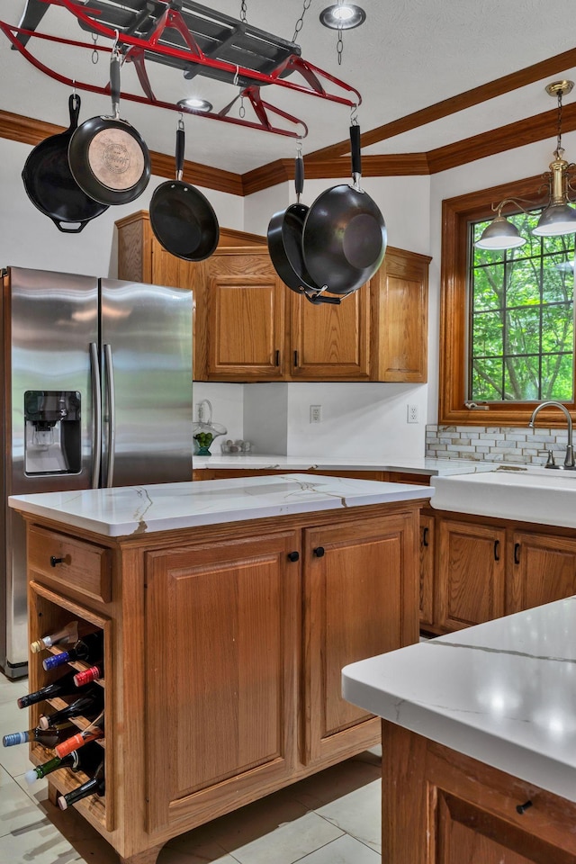 735 Keytown Rd, Portland, TN 37148 - kitchen featuring light countertops, stainless steel fridge with ice dispenser, brown cabinets, crown molding, and light tile patterned floors