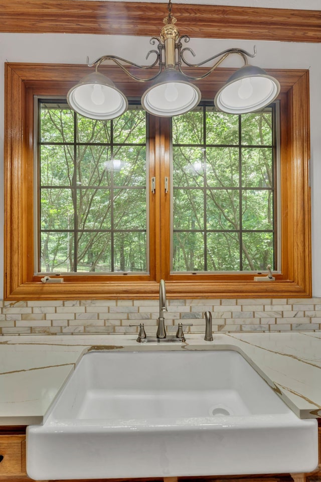 735 Keytown Rd, Portland, TN 37148 - kitchen view of a sink, light stone counters, and brown cabinetry