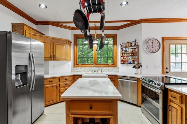 735 Keytown Rd, Portland, TN 37148 - kitchen with appliances with stainless steel finishes, a sink, brown cabinets, tasteful backsplash, and ornamental molding