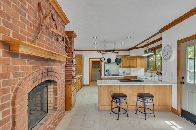 735 Keytown Rd, Portland, TN 37148 - kitchen featuring a peninsula, gas cooktop, light countertops, ornamental molding, and a fireplace