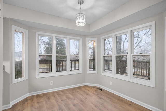 unfurnished sunroom featuring a chandelier and visible vents