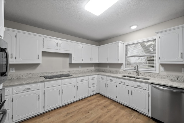 kitchen featuring light wood-style floors, white cabinets, a sink, dishwasher, and black electric cooktop