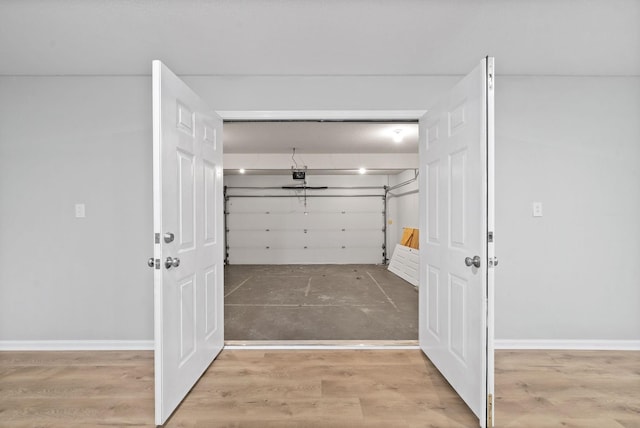 garage featuring baseboards and a garage door opener