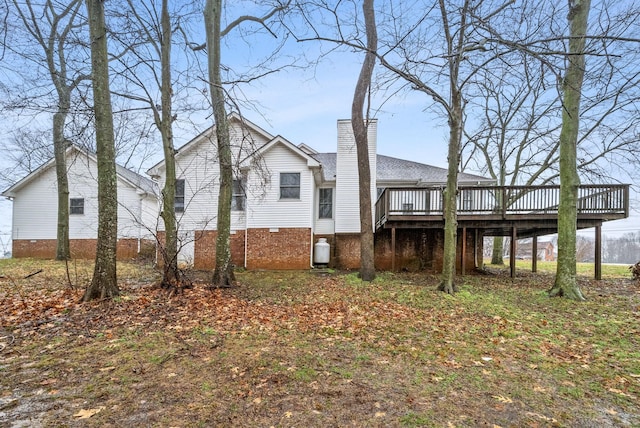 back of property featuring a chimney and a deck