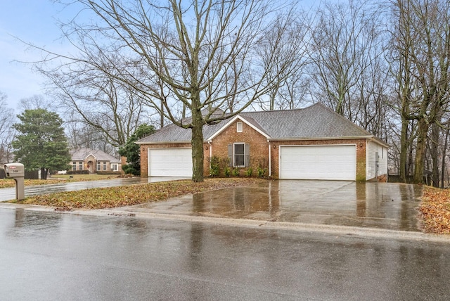 ranch-style home with driveway, a shingled roof, and brick siding