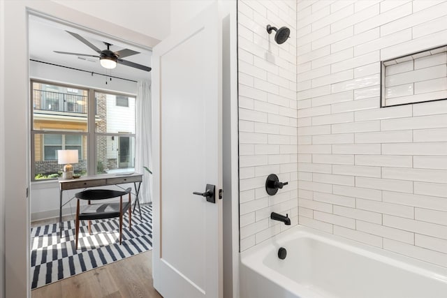 full bath featuring  shower combination, ceiling fan, and wood finished floors