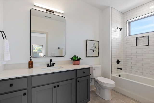 bathroom with visible vents, toilet, vanity, shower / tub combination, and tile patterned floors