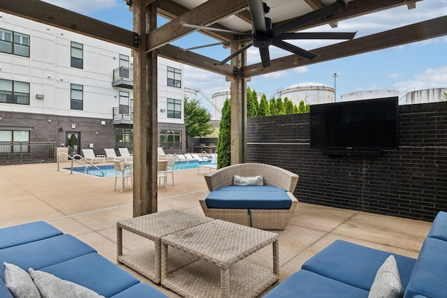 view of patio featuring ceiling fan, a community pool, and an outdoor hangout area