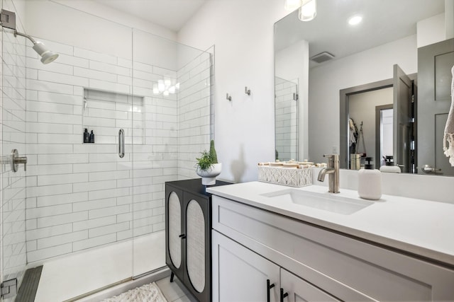 bathroom featuring a stall shower, visible vents, and vanity