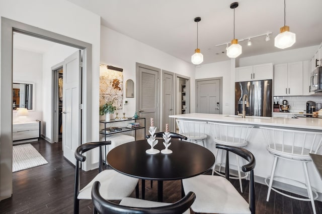 dining space featuring dark wood-style flooring