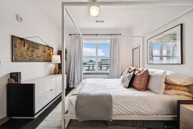 bedroom with dark wood-type flooring and visible vents