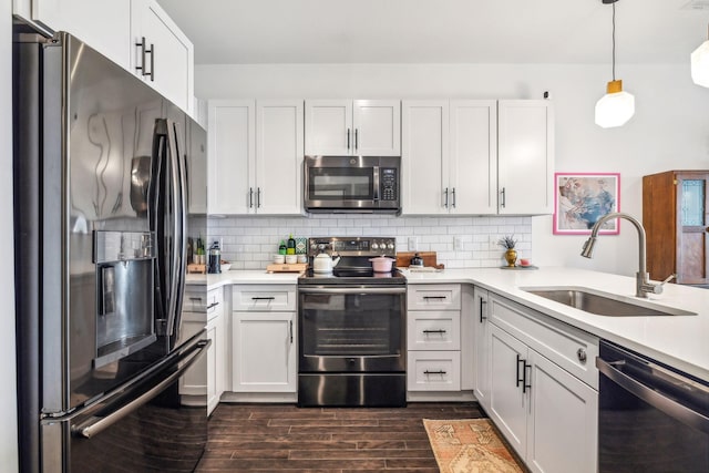 kitchen featuring appliances with stainless steel finishes, a sink, and white cabinets