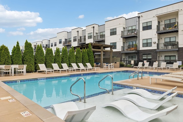 pool featuring a patio area and fence