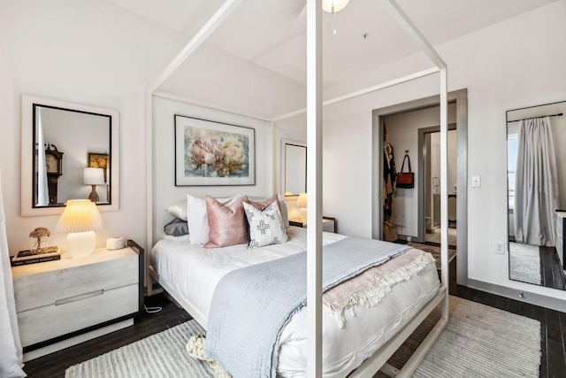 bedroom with dark wood-style flooring