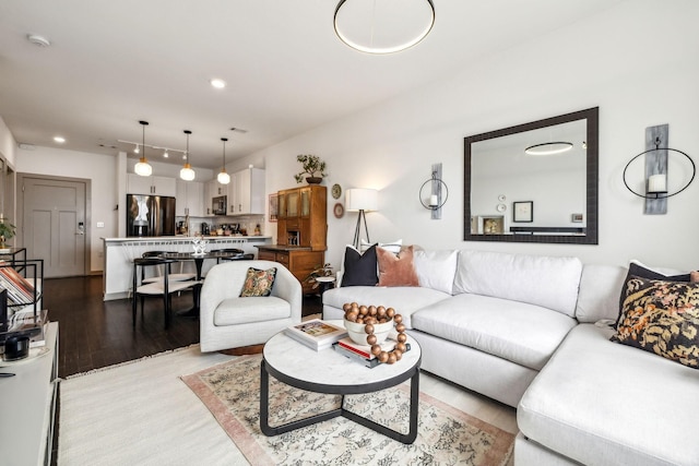 living area featuring light wood finished floors and recessed lighting