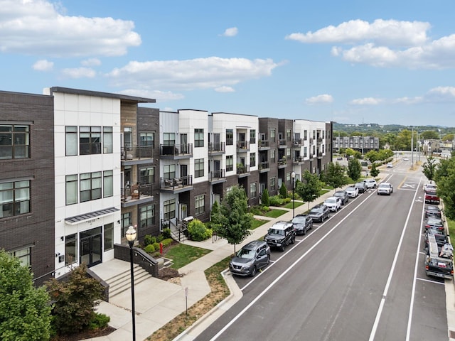 view of building exterior featuring uncovered parking