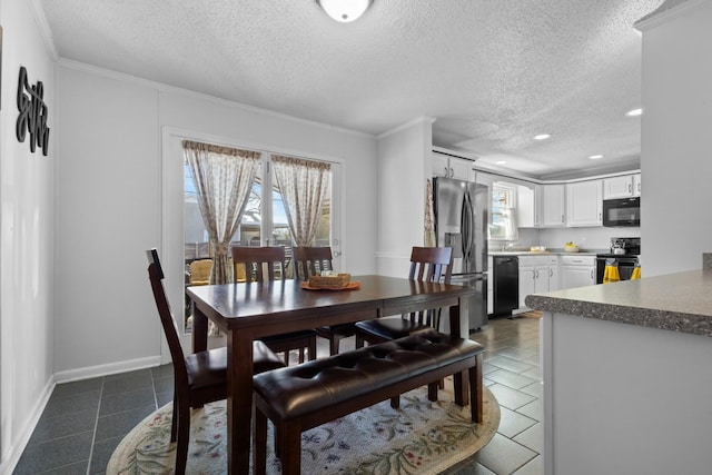 dining room with ornamental molding, dark tile patterned flooring, a textured ceiling, and baseboards