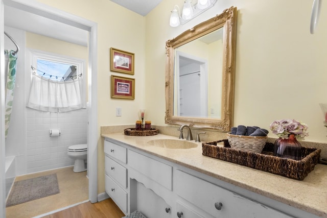 full bathroom with tile walls, shower / bath combination with curtain, toilet, vanity, and wood finished floors