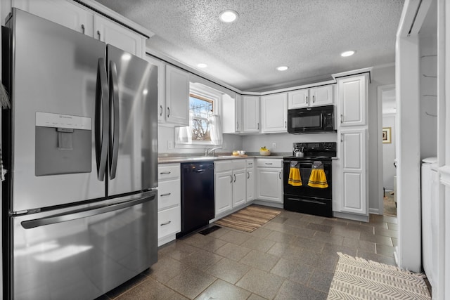 kitchen with light countertops, a textured ceiling, black appliances, white cabinetry, and recessed lighting