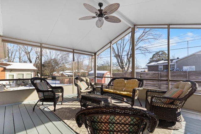 sunroom / solarium with a ceiling fan and vaulted ceiling with beams