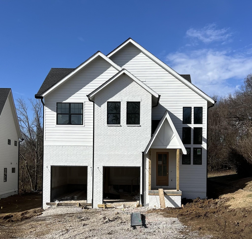 view of front of house featuring brick siding and an attached garage