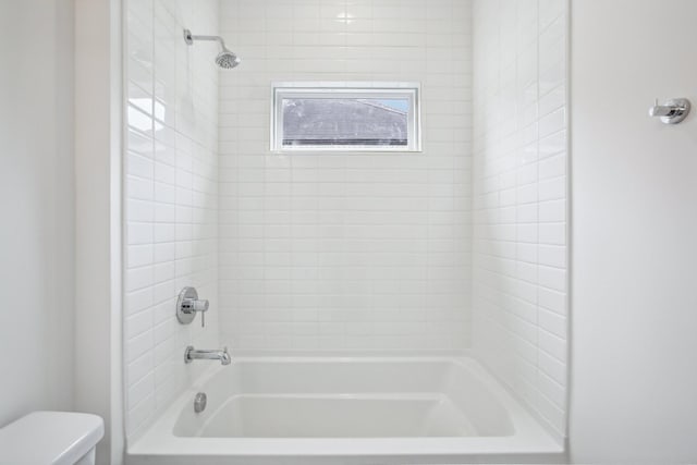 bathroom with toilet and shower / tub combination