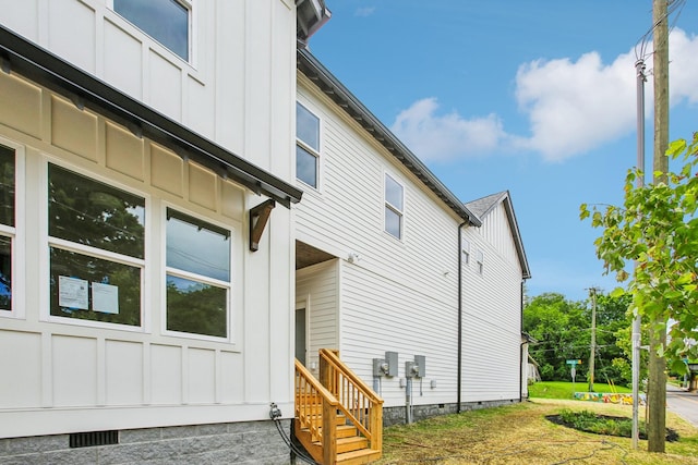 view of home's exterior featuring crawl space and board and batten siding