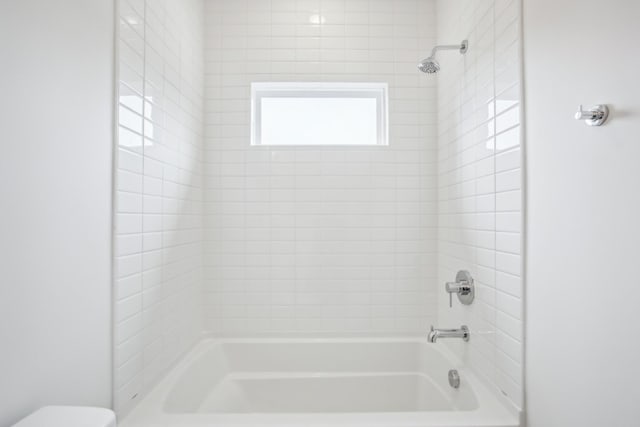 full bath with washtub / shower combination and toilet