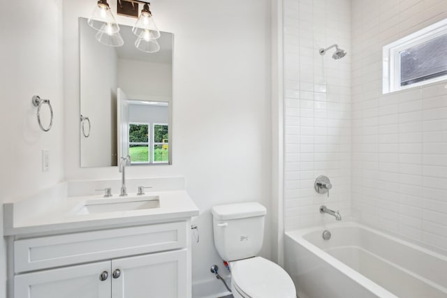 bathroom featuring toilet, vanity, and bathing tub / shower combination