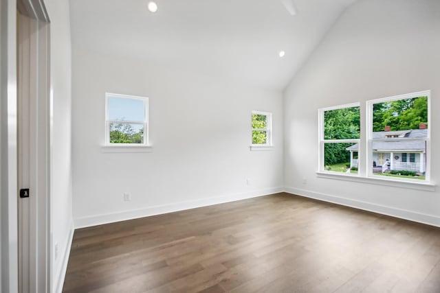 spare room with high vaulted ceiling, baseboards, dark wood-style flooring, and recessed lighting