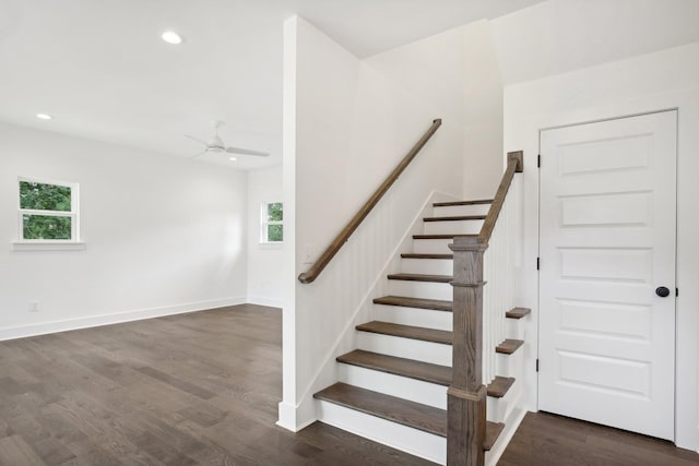 staircase featuring baseboards, plenty of natural light, wood finished floors, and recessed lighting