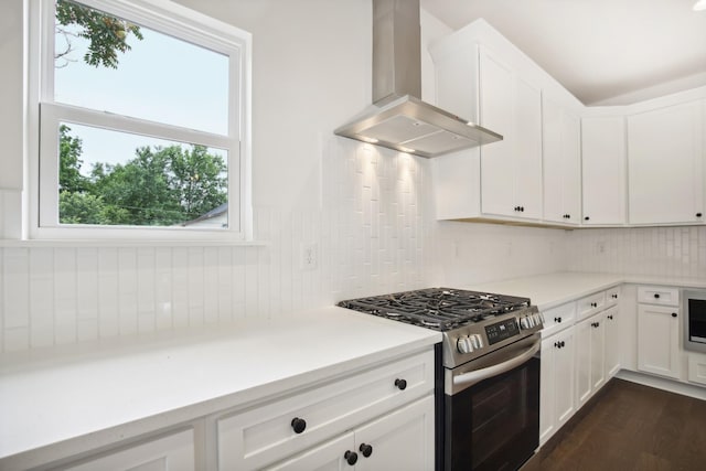 kitchen with light countertops, decorative backsplash, white cabinetry, stainless steel gas stove, and exhaust hood