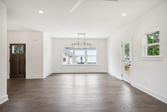 foyer entrance with a notable chandelier, baseboards, dark wood-type flooring, and recessed lighting