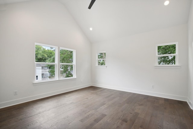 empty room featuring high vaulted ceiling, baseboards, dark wood finished floors, and recessed lighting