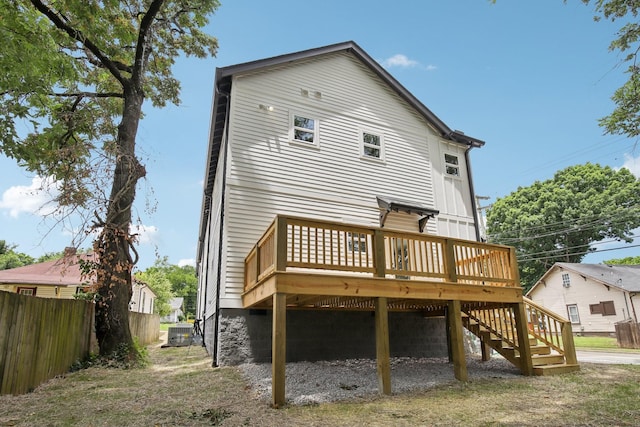 rear view of property featuring central AC unit, stairs, fence, and a deck