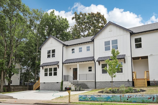 modern farmhouse style home featuring board and batten siding, crawl space, and roof with shingles