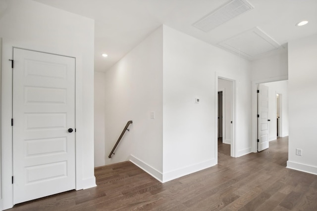 empty room featuring attic access, visible vents, baseboards, dark wood-style floors, and recessed lighting