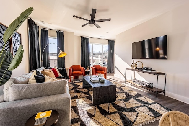 living area with ceiling fan, dark wood finished floors, visible vents, and baseboards