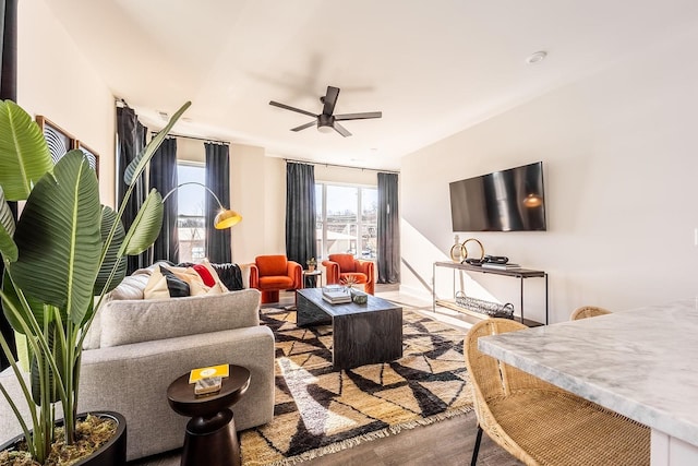 living area featuring ceiling fan and wood finished floors