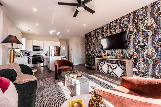 living area with baseboards, a ceiling fan, dark wood-style flooring, and recessed lighting