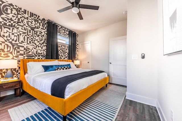 bedroom featuring ceiling fan, dark wood-type flooring, and baseboards