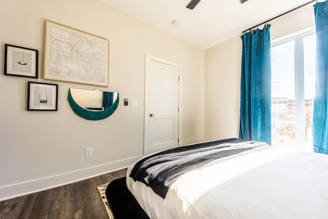 bedroom featuring a ceiling fan, baseboards, and dark wood-type flooring