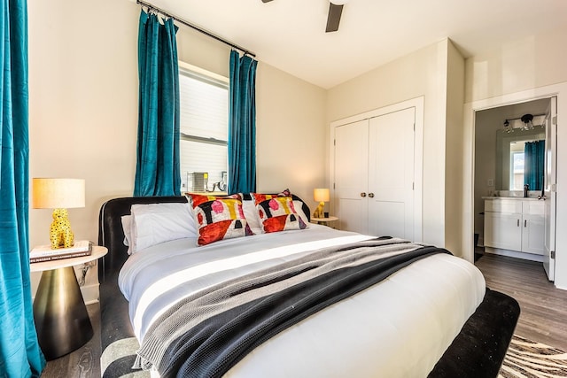 bedroom featuring dark wood-type flooring, a closet, and a ceiling fan