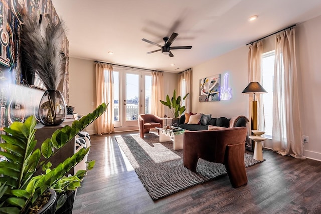 living area featuring french doors, dark wood finished floors, baseboards, and ceiling fan