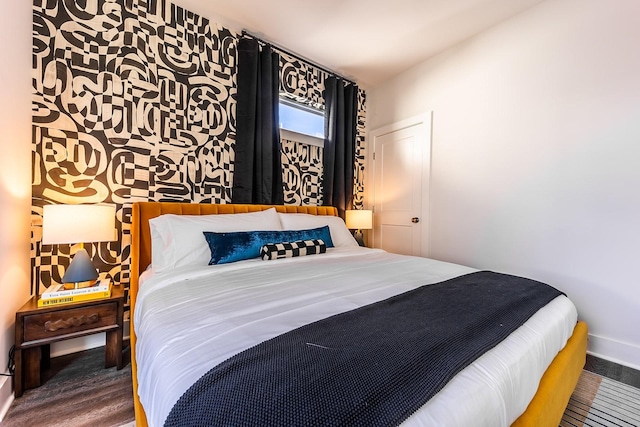 bedroom featuring wood finished floors and baseboards