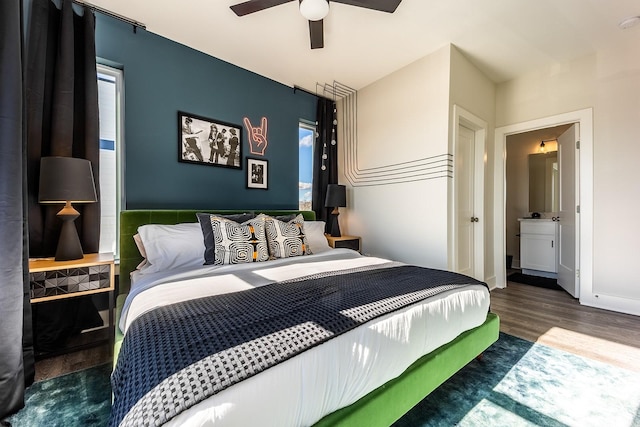 bedroom featuring ceiling fan, multiple windows, baseboards, and dark wood-type flooring